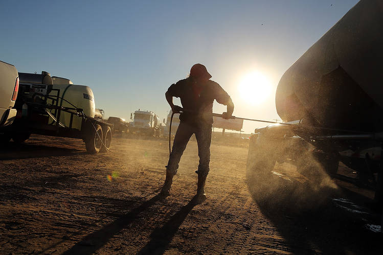 A truck used to carry sand for fracking is washed in a truck stop on February 4, 2015 in Odessa, Texas.