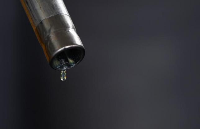 A drop of diesel is seen at the tip of a nozzle after a fuel station customer fills her car